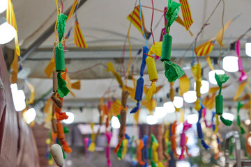 Decorations under the ceiling of a tent selling churros imitating firecrackers