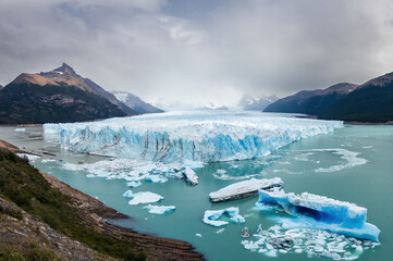 Majestic Blue Glacier amidst Mountains and Icebergs