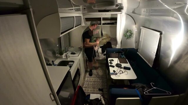 Time-lapse man cleaning packing bag with camera gear 