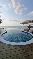 A stunning, large swimming pool blends seamlessly with a wooden deck under the open sky