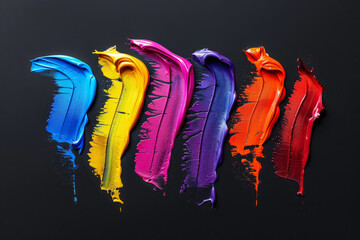 A colorful line of paint with a rainbow of colors. The colors are bright and bold, creating a sense of energy. is abstract and artistic. colorful paint brush strokes isolated on black background
