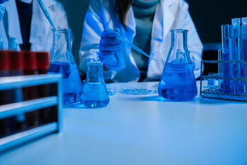 Science and medicine, scientist analyzing and dropping a sample into a glassware, experiments containing chemical liquid in laboratory on glassware, innovative and technology.