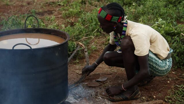 Man boiling a Water Pot to pure it