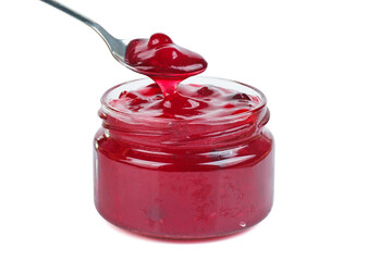Cranberry jam in glass jare with spoon isolated on a white background