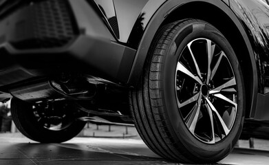 black Car in showroom. Aluminum wheel with  Tire. automobile wheel tire.  aluminium rims. Motor Corporation is Japanese automotive manufacturer. 4х4. 4wd.