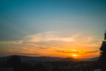 Beautiful orange sunrise over the city landscape on the horizon