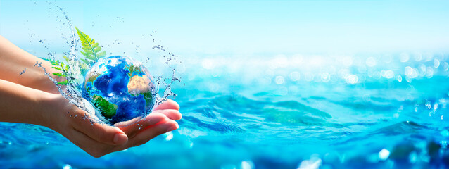 Ocean Environment Concept - Hands Holding Globe Glass In Blue Sea With Defocused Lights - Contain...