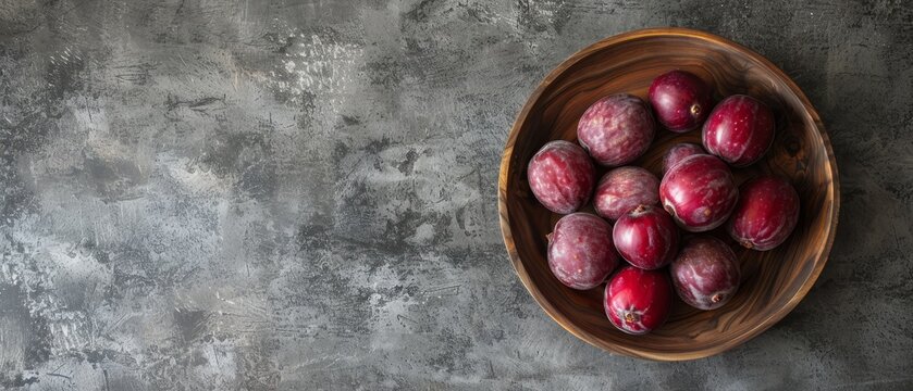   A wooden bowl sits atop a cement floor, holding red apples Another wooden bowl nearby also contains red apples