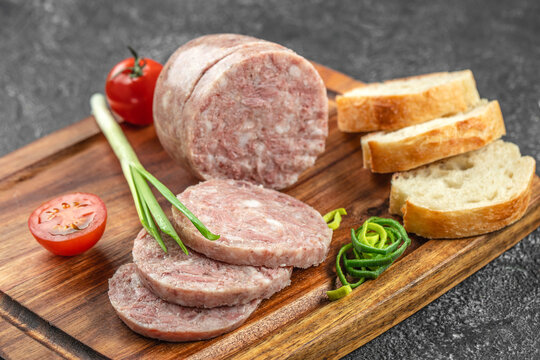 Headcheese chopped. pork meat product on a wooden board, top view. copy space