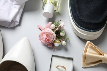 Wedding stuff. Composition with stylish boutonniere on light gray background, closeup - obrazy, fototapety, plakaty