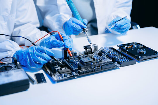 The technician is putting the CPU on the socket of the computer motherboard. electronic engineering electronic repair, electronics measuring.