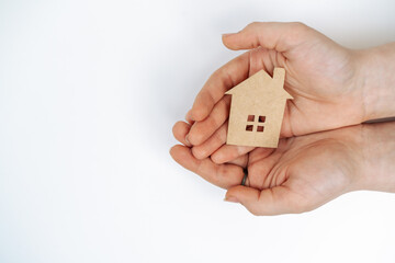 hands holding paper house, family home, homeless housing, mortgage crisis and home protecting insurance concept, foster home care, family day care, social distancing.
