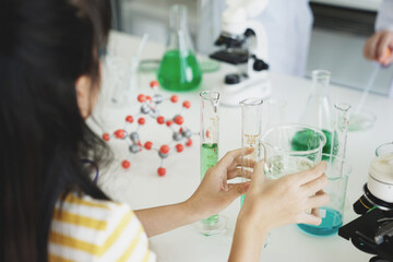 Kids school class with back shot education science studying learning test experiment in lab.