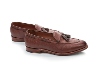 Two Traditional Formal Stylish Brown Pebble Grain Tassel Loafer Shoes On White Reflective Surface. - 770483933