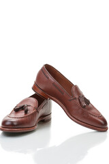 Two Traditional Formal Stylish Brown Pebble Grain Tassel Loafer Shoes On White Reflective Surface. - 770483969