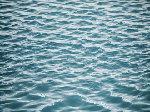 Blue water surface texture background. Close up of rippled water surface.