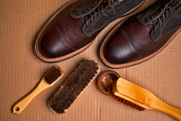 Upper View of Various Shoes Cleaning Accessories for Dark Brown Grain Brogue Derby Boots Made of Calf Leather Over Paper Background - 770486391