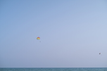 Experience the thrill of parasailing - an extreme sport combining adventure and travel. Capture aerial views of tourist landmarks with adrenaline-pumping excitement. Perfect for adventurers!