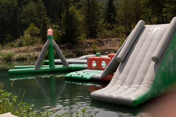 Inflatable water slides provide aquatic fun at a water park. Amusement park attractions, ideal for...