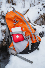 First aid kit backpack left on snowy slope during freezing event