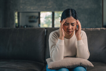 Depressed and Stressed asian woman on sofa. Crying sadness female alone in home problem in life....