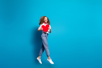 Fototapeta na wymiar Photo portrait of pretty young woman running excited big red heart postcard dressed stylish white clothes isolated on blue color background