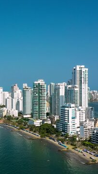 Aerial vertical panoramic hyperlapse video of the new modern district Bocagrande in Cartagena with the sea and the skyline, Colombia