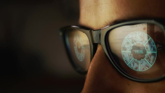 In the reflection of glasses on a male face, he is surfing the Internet and a pie digital chart showing one hundred percent loading. Cg
