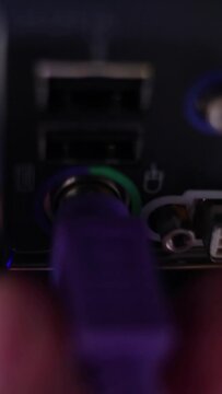 PS2 connector on motherboard, Hand connects plugs in a PS2. Vertical video.