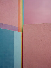 A bright rainbow appears between two vibrantly painted pink walls