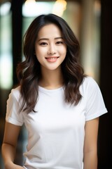 Fototapeta premium Portrait of Asian lovely woman with dark curly hair posing with kind smile, isolated over blurry background. Generative AI.