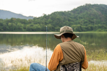 Enjoy moment of Handsome man fishing as a leisure activity during his vacation at the lake on...