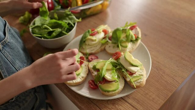 Little Girl Making Healthy Fresh Sandwiches Decorating With Spinach. Healthy Vegetable Sandwiches With Cheese Tomatoes And Avocado