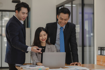 A group of employees happily work together in the office while discussing work that was completed on time as ordered by their boss, A group of entrepreneurs had fun working together.