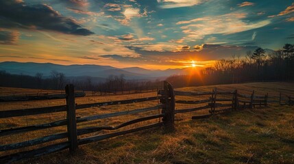 Obraz premium Sunrise over the mountain range with a wooden fence in the foreground.