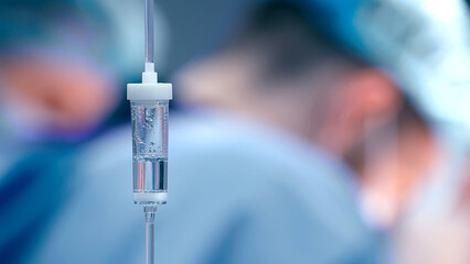Close-up of the infusion process. A drop of saline is dropped for intravenous infusion.