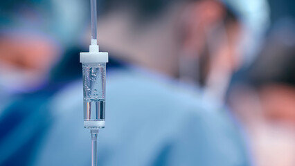 Close-up of the infusion process. A drop of saline is dropped for intravenous infusion.