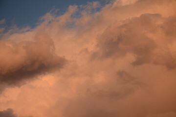 Pink evening clouds on a blue sky