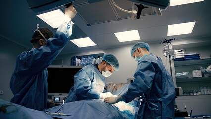 A team of professional surgeons perform an operation in a modern hospital. Medical staff, surgical concept.
