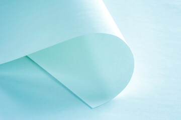 Sheets of paper from a roll of cold pastel color as a background.