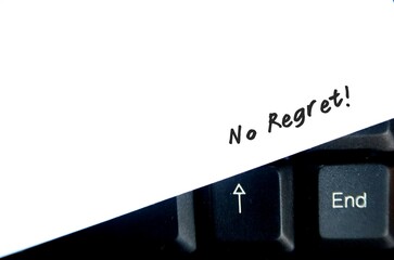 Handwritten text on paper on keyboard : No regret -  to live a life without feeling bad about what...