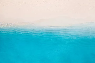 Summer seascape beautiful waves, blue sea water in sunny day. Top view from drone. Sea aerial view, amazing tropical nature background. Beautiful bright sea with waves splashing and beach sand concept © icemanphotos