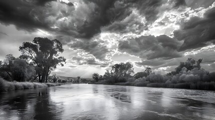 Dramatic Cloudy Skies Reflecting on Serene River Landscape in Rural Wilderness
