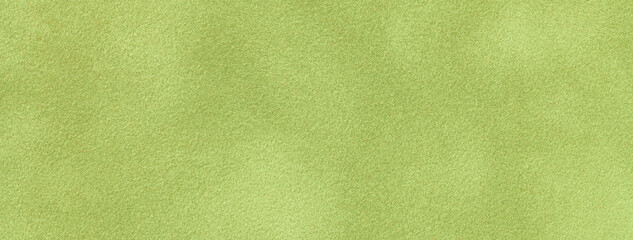 Texture of light green velvet matte background, macro. Suede olive fabric with pattern.