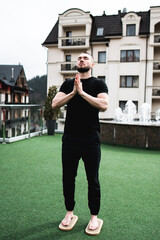 A man stands on the Sadhu boards on the terrace in rainy weather.Nailing and meditation concept