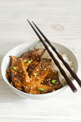 Eryngii mushroom fried with sesame and green onion and white boiled rice in a gray bowl. Dishes Gochujang King Oyster Mushrooms. Traditional Korean cuisine. Vertical orientation. - obrazy, fototapety, plakaty