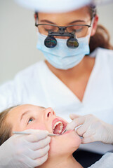 Obraz na płótnie Canvas Girl, child and mouth inspection at dentist for healthcare with dental mirror, closeup consultation or checkup for oral health. Magnifying glass, kid or glove hand for teeth cleaning and medical care