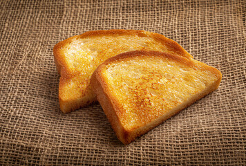 Two slices of toast on burlap