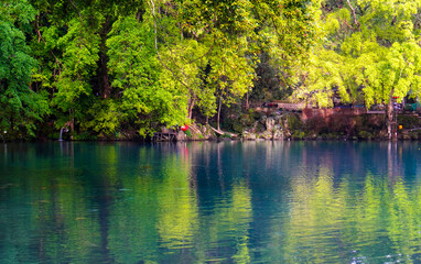 Beautiful view of the blue lake surrounded by trees around it.