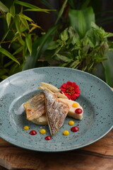 Grilled sea bass fillet with raspberries sauce and white polenta Fusion food
